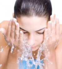 Beautiful woman washing her face