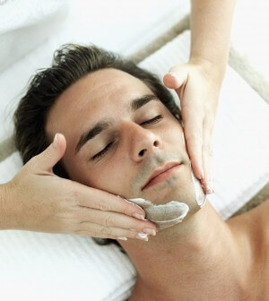 Elevated view of a young man getting a facial